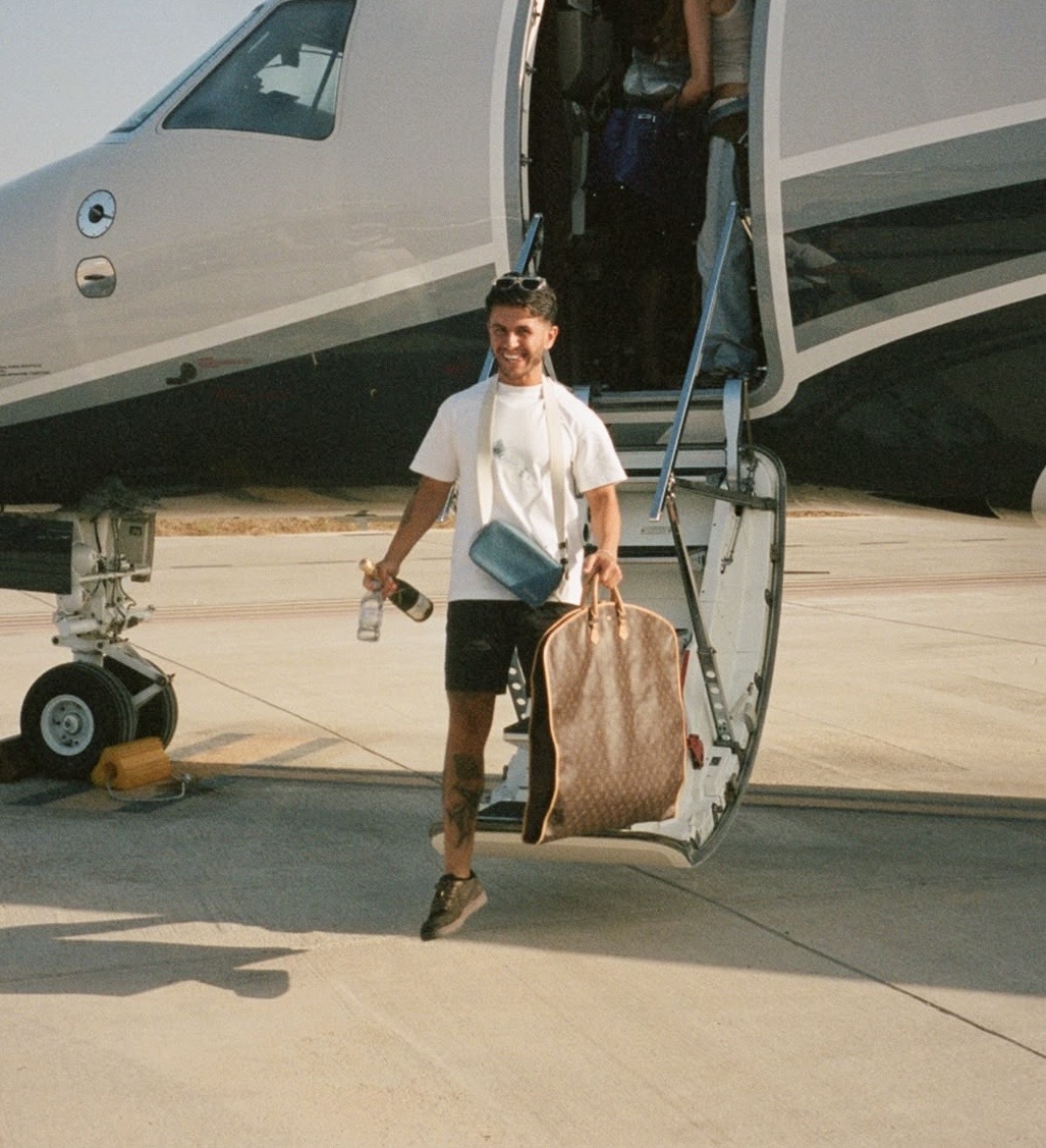 Matty Cummings stepping off an aircraft on a sunlit runway